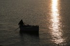 Pescatore di rientro al tramonto, dopo una giornata di pesca.