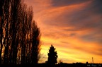 La luce del crepuscolo che illumina nuvole ed oscura la vegetazione delle crete senesi