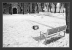 Una foto di cui mi ero quasi scordato risalente all'inverno scorso e scattata Brescia. Una scena abbastanza surreale: una piazza innevata, la presenza umana suggerita da un vecchio televisore abbandonato davanti ad una panchina come se fosse stato appena utilizzato. 
Brescia, p.za T. Brusato
[Nikkormat ftn + ob AI 50 mm. Konica monochrome VX400]