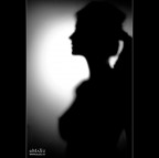 Behind...a woman.