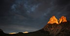 L'ultima luce dell'alba, quasi un miracolo, illumina le cime del Sassolungo prima di un violento temporale estivo - immagine ripresa nei pressi del Passo Sella (Dolomiti)